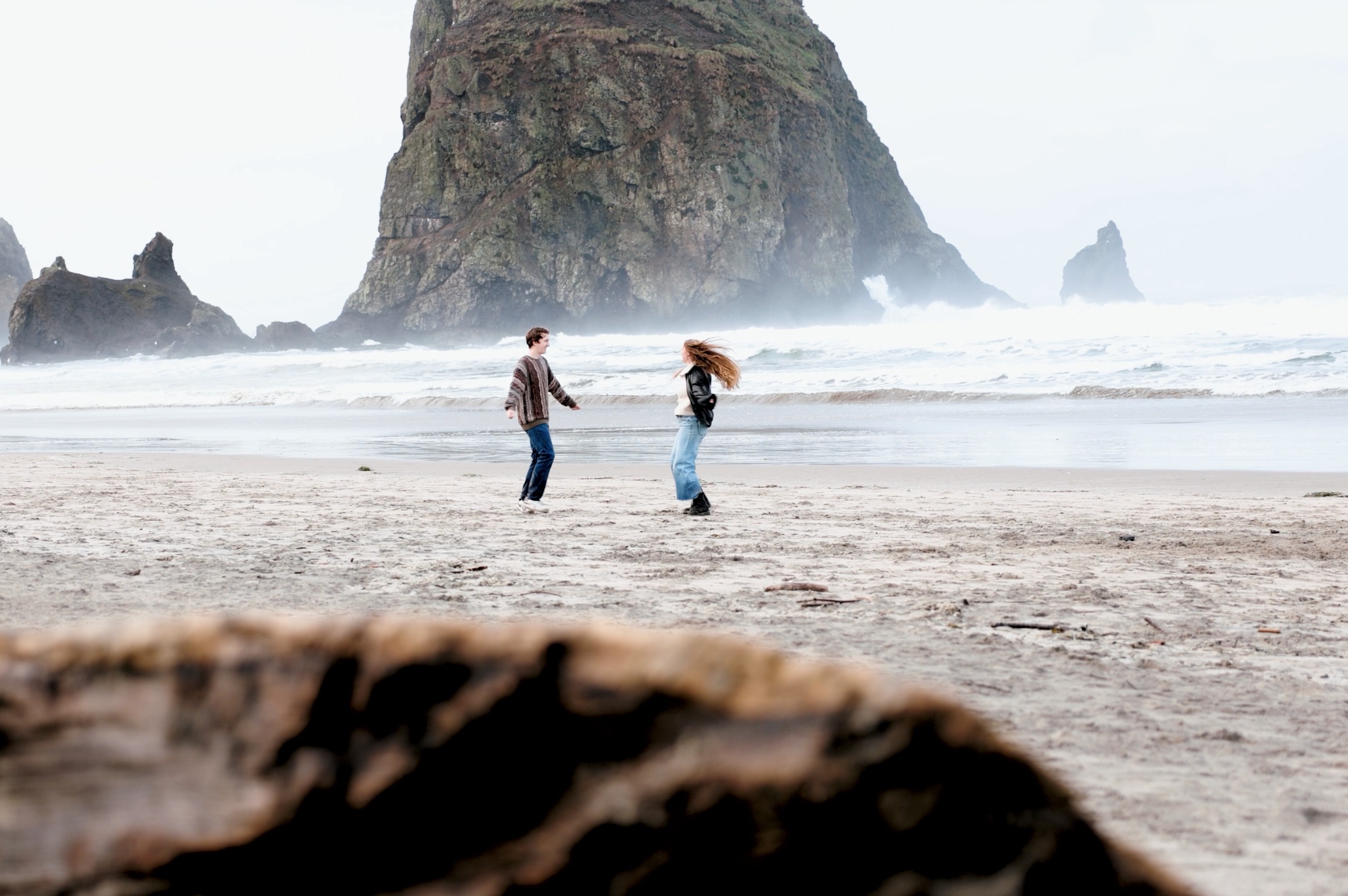 Casual couple on beach with Haystack Rock