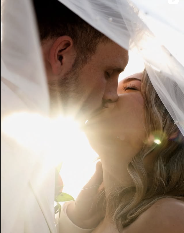 Intimate couple moment under veil